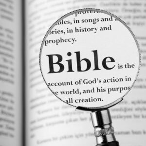 Bible with magnifying glass